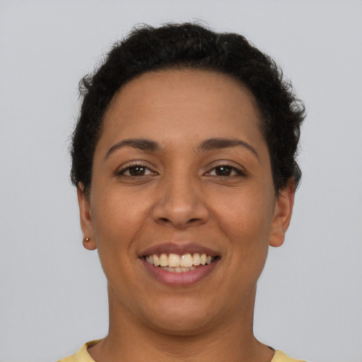 Joyful latino young-adult female with short  brown hair and brown eyes