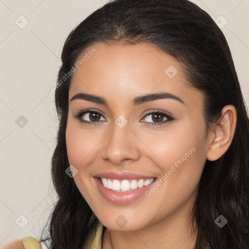 Joyful latino young-adult female with long  brown hair and brown eyes