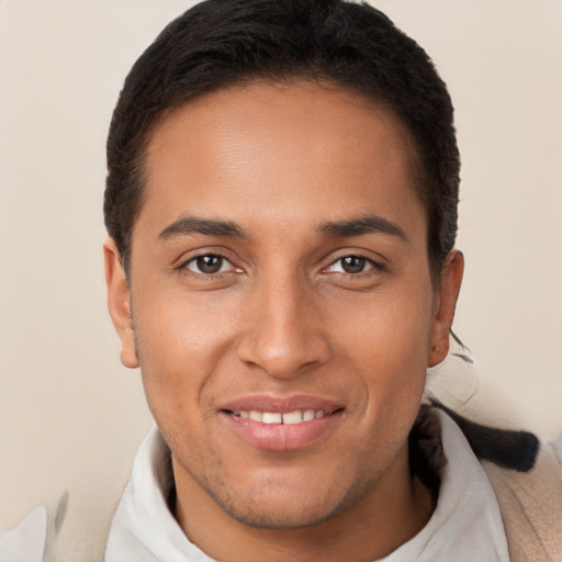 Joyful latino young-adult male with short  brown hair and brown eyes