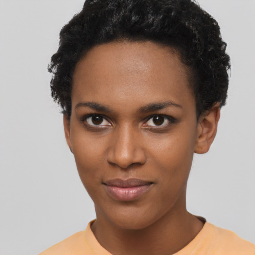 Joyful black young-adult female with short  black hair and brown eyes