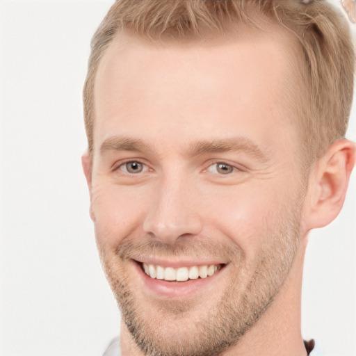 Joyful white young-adult male with short  brown hair and grey eyes