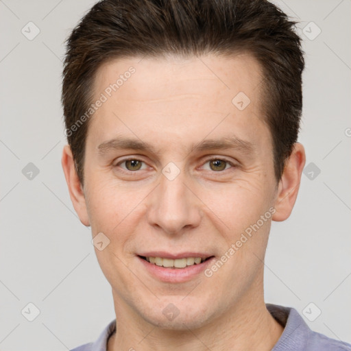 Joyful white young-adult male with short  brown hair and brown eyes