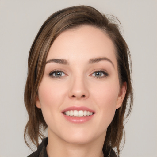 Joyful white young-adult female with medium  brown hair and grey eyes