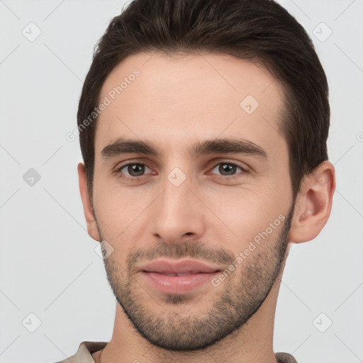 Joyful white young-adult male with short  brown hair and brown eyes