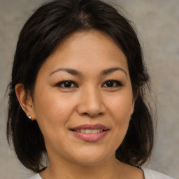 Joyful asian adult female with medium  brown hair and brown eyes