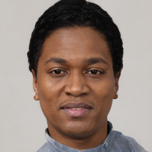 Joyful black adult male with short  black hair and brown eyes