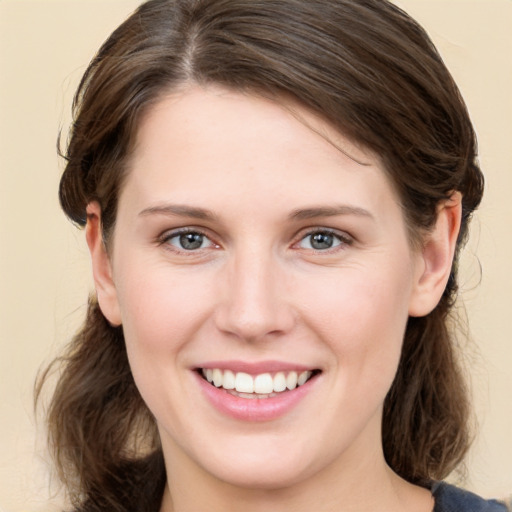 Joyful white young-adult female with medium  brown hair and brown eyes