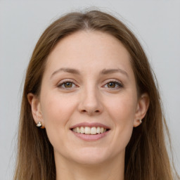 Joyful white young-adult female with long  brown hair and grey eyes