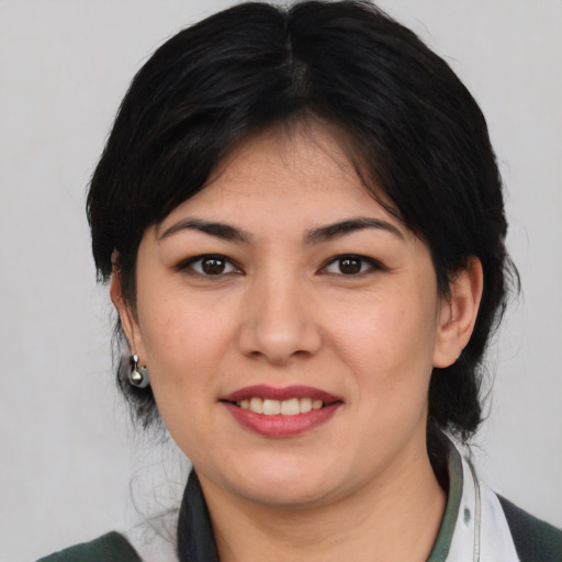 Joyful asian young-adult female with medium  brown hair and brown eyes