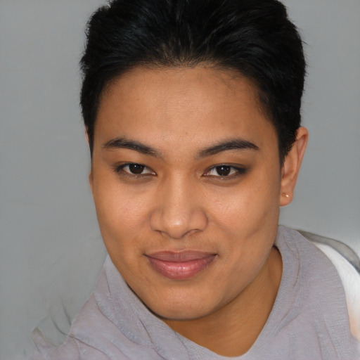 Joyful latino young-adult female with short  brown hair and brown eyes