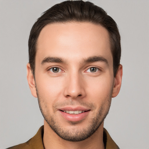 Joyful white young-adult male with short  brown hair and brown eyes