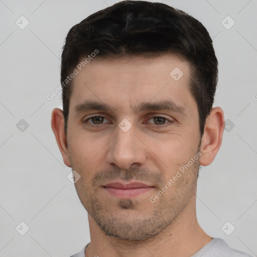 Joyful white young-adult male with short  black hair and brown eyes