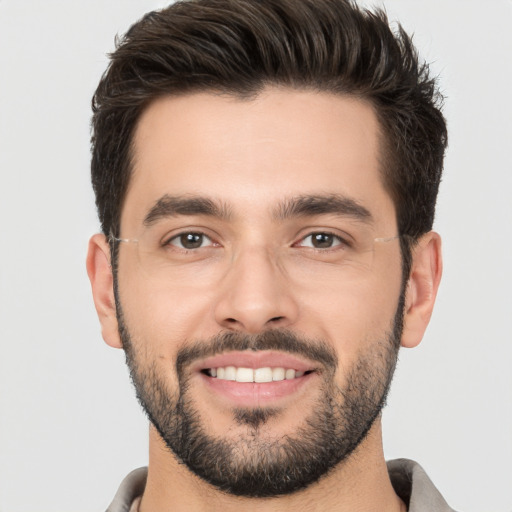 Joyful white young-adult male with short  brown hair and brown eyes