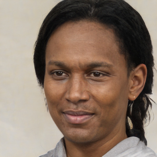 Joyful latino adult male with medium  black hair and brown eyes