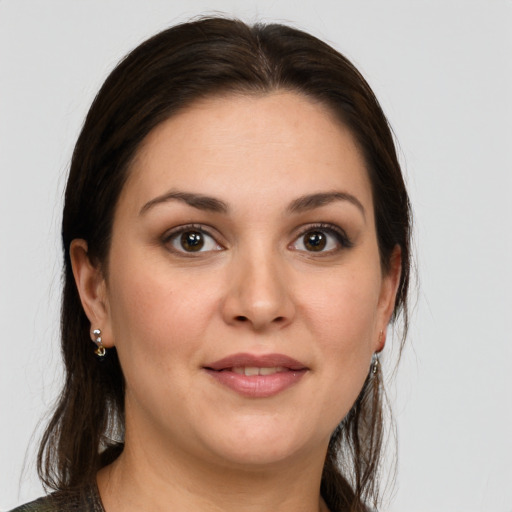 Joyful white young-adult female with medium  brown hair and brown eyes