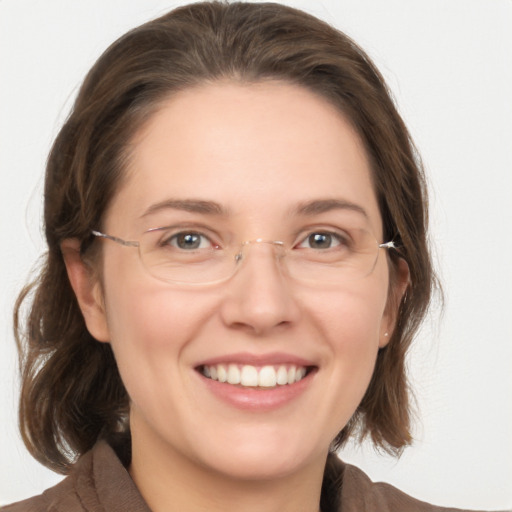 Joyful white adult female with medium  brown hair and grey eyes