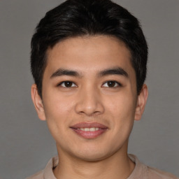 Joyful asian young-adult male with short  brown hair and brown eyes