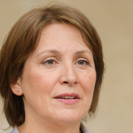 Joyful white adult female with medium  brown hair and green eyes