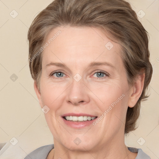 Joyful white adult female with medium  brown hair and grey eyes