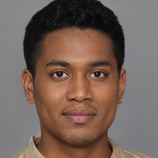 Joyful black young-adult male with short  brown hair and brown eyes