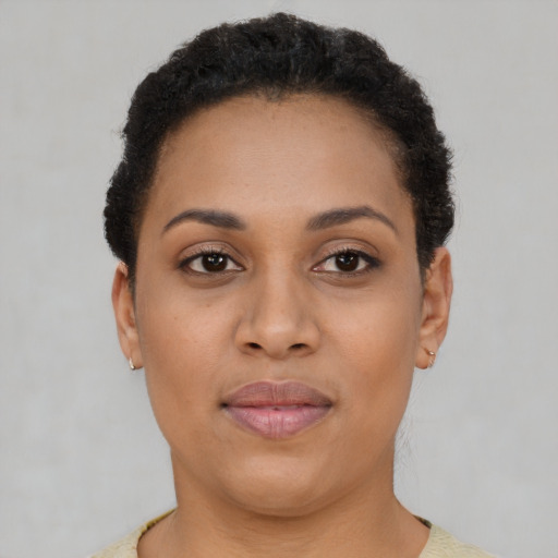 Joyful latino young-adult female with short  brown hair and brown eyes