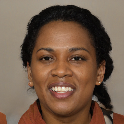 Joyful black young-adult female with medium  black hair and brown eyes