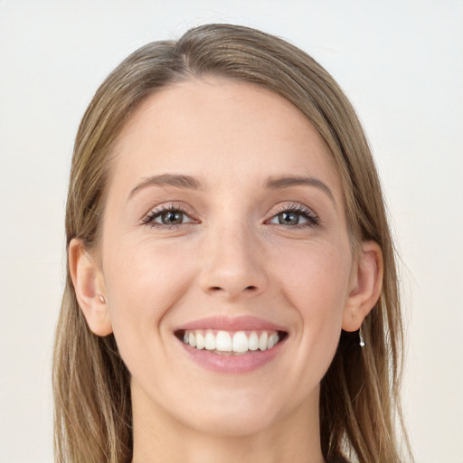 Joyful white young-adult female with long  brown hair and grey eyes