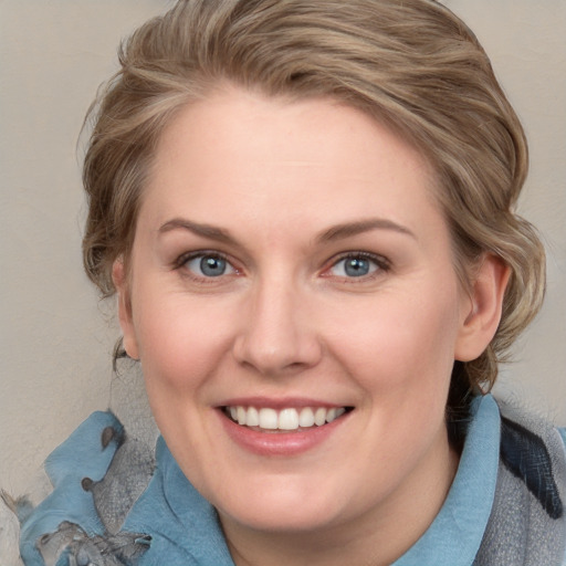 Joyful white young-adult female with medium  brown hair and blue eyes