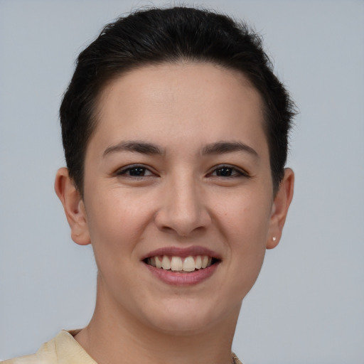 Joyful white young-adult female with short  brown hair and brown eyes