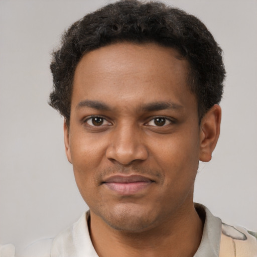 Joyful black young-adult male with short  black hair and brown eyes