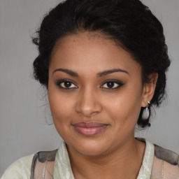 Joyful black young-adult female with medium  brown hair and brown eyes