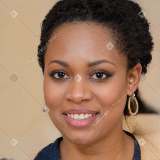 Joyful black young-adult female with long  brown hair and brown eyes