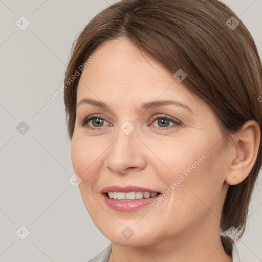 Joyful white adult female with medium  brown hair and brown eyes