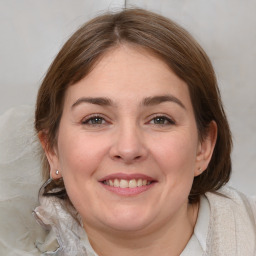 Joyful white young-adult female with medium  brown hair and grey eyes