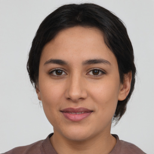 Joyful latino young-adult female with medium  black hair and brown eyes