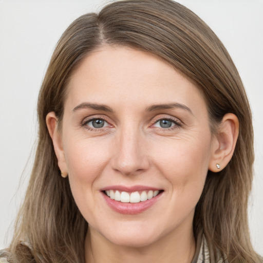 Joyful white young-adult female with long  brown hair and grey eyes