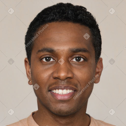 Joyful black young-adult male with short  black hair and brown eyes