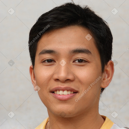 Joyful asian young-adult male with short  black hair and brown eyes