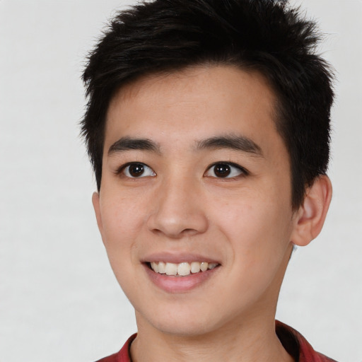 Joyful asian young-adult male with short  black hair and brown eyes