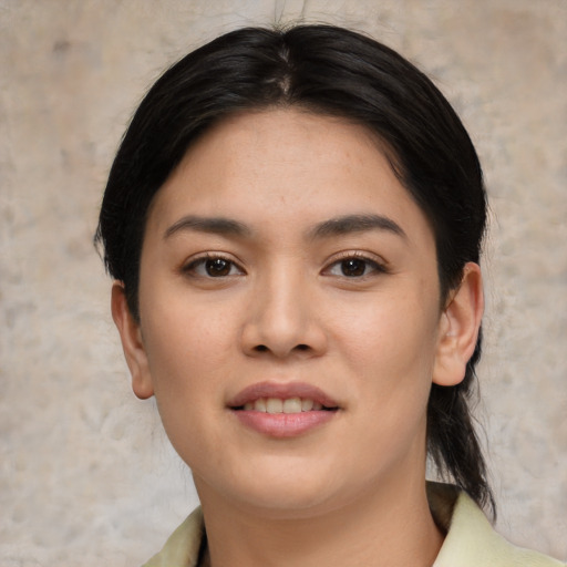 Joyful asian young-adult female with medium  black hair and brown eyes