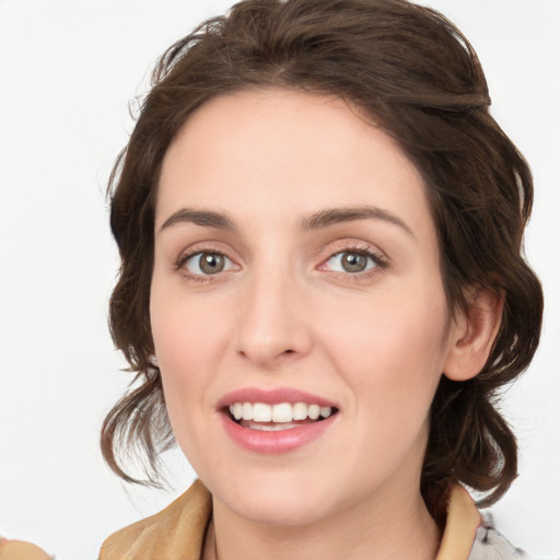 Joyful white young-adult female with medium  brown hair and green eyes