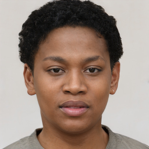 Joyful black young-adult female with short  black hair and brown eyes