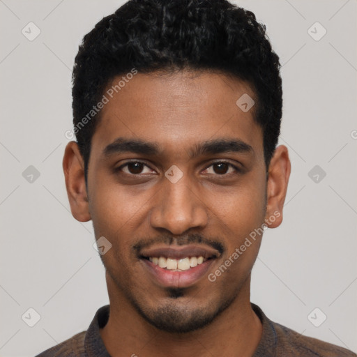 Joyful black young-adult male with short  black hair and brown eyes