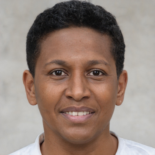 Joyful black young-adult male with short  brown hair and brown eyes