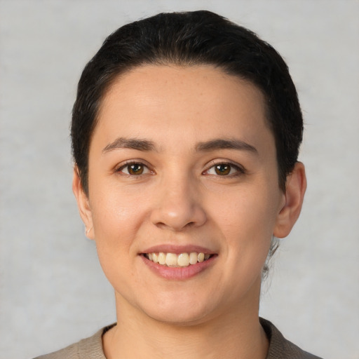 Joyful white young-adult female with short  black hair and brown eyes