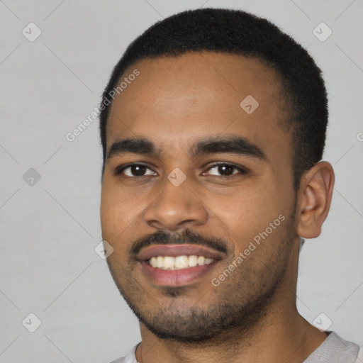 Joyful black young-adult male with short  black hair and brown eyes