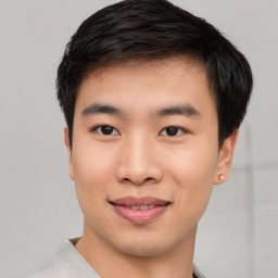 Joyful asian young-adult male with short  black hair and brown eyes