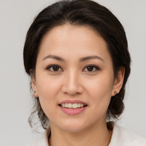 Joyful white young-adult female with medium  brown hair and brown eyes