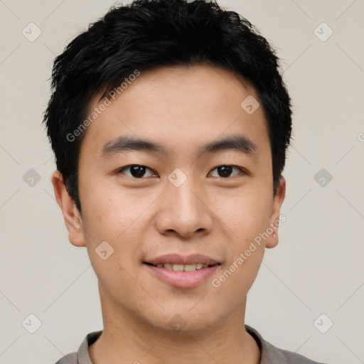 Joyful asian young-adult male with short  black hair and brown eyes