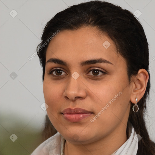 Joyful latino young-adult female with medium  brown hair and brown eyes